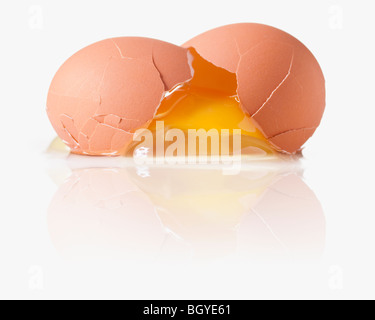 Cracked egg with a shattered yoke Stock Photo