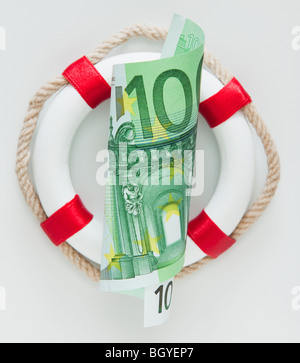 Ring bouy behind European currency Stock Photo