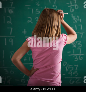 Student in front of chalkboard Stock Photo