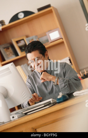 Man working at computer Stock Photo