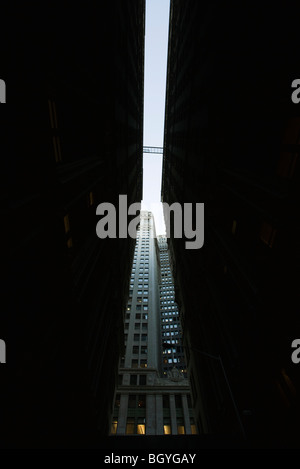 High rise seen at end of narrow alley, low angle view Stock Photo