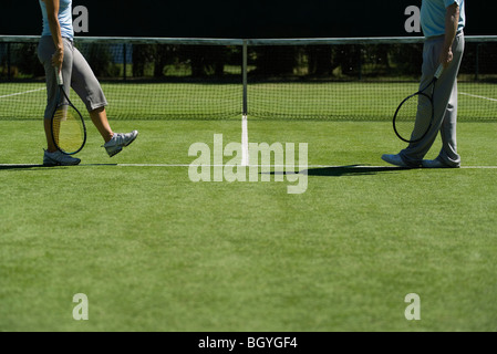 Tennis players walking across court to meet, cropped Stock Photo