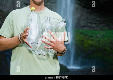 Man holding empty water bottles Stock Photo