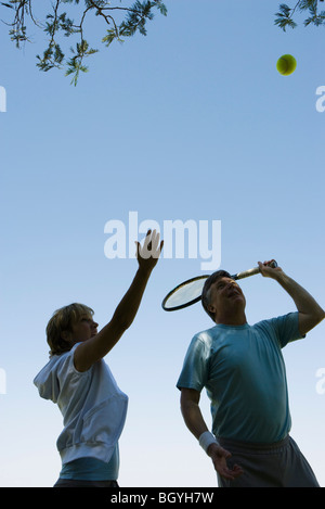 Tennis player coached on serve form Stock Photo