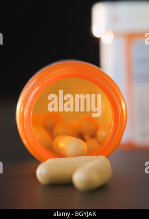 Pills spilled from container Stock Photo