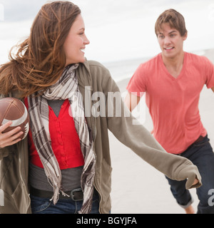 Couple playing football Stock Photo