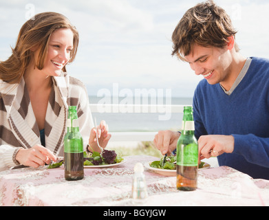 Couple eating at the beach Stock Photo