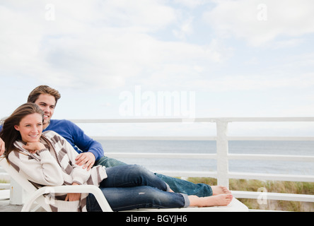 Couple on lounge chair Stock Photo