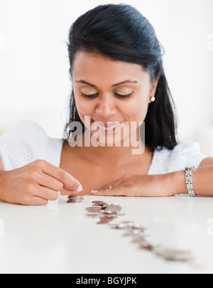 Woman stacking coins Stock Photo