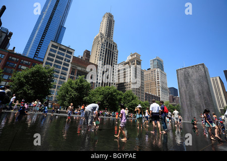 All generations of people playing in spouting water at the Crown Fountains in the Millennium Park Chicago, Illinois, USA Stock Photo