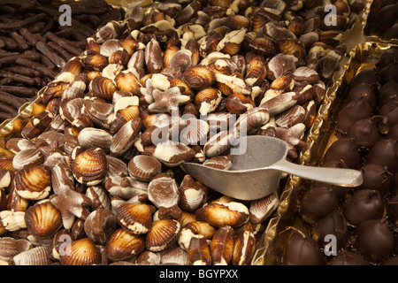 Display of Belgian Seashell chocolates with serving scoop Stock Photo