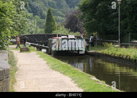 A narrow boat at a lock on the Rochdale Canal at Hebden Bridge UK. Stock Photo