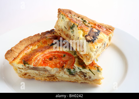 Two slices of a vegetarian mushroom quiche on a white plate Stock Photo