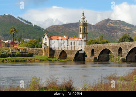 Roman bridge, and the church of Santo Antonio da torre velha, over the river Lima in Ponte Lima, Portugal. Stock Photo