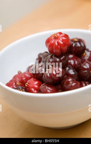 A bowl of pitangas or Surinam Cherries, the fruit from the Eugenia uniflora tree, Stock Photo