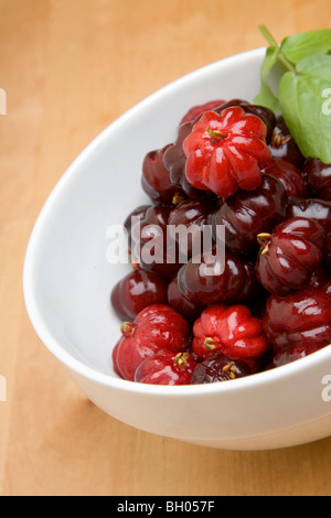 A bowl of pitangas or Surinam Cherries, the fruit from the Eugenia uniflora tree, Stock Photo