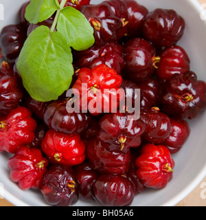 A bowl of pitangas or Surinam Cherries, the fruit from the Eugenia uniflora tree, Stock Photo