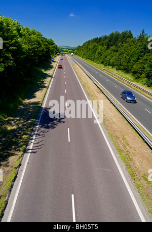 Dual carriageway road with white lines and crash barrier in centre Stock Photo