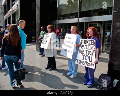 Health care workers at a NY City clinic hold a sidewalk protest against compulsory inoculations of H1N1 swine flu vaccine. Stock Photo