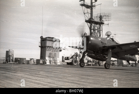 U.S. Navy Corsair airplanes fly onto and off the deck of the naval aircraft carrier Saipan during student pilot training in 1946 Stock Photo