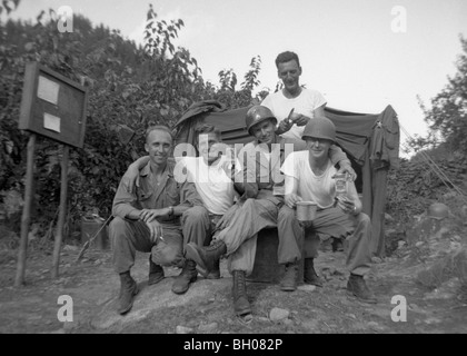 Officers of the Second Infantry Division relax for a group photo while drinking their beer ration during the Korean War. Stock Photo