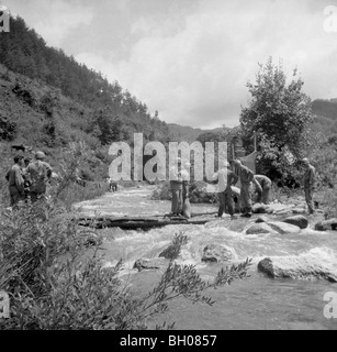 During a break from Korean War fighting members of the U.S. Army, Second Infantry Division do laundry in a river. Stock Photo