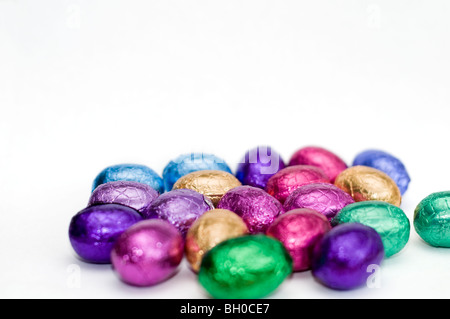 A selection of colorful mini chocolate Easter eggs on a white background Stock Photo