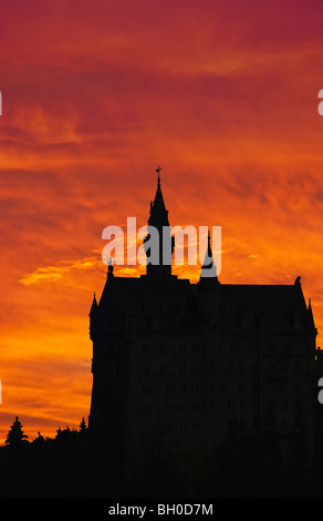 Silhouette of Neuschwanstein, worldwide famous german castle in bavarian Alps, Germany, outlined by sunset Stock Photo