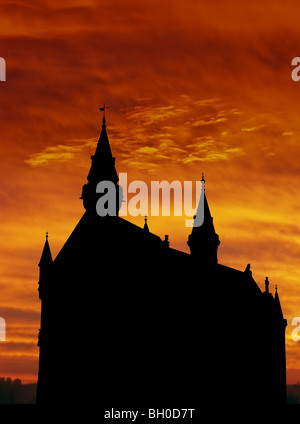 Silhouette of Neuschwanstein, worldwide famous german castle in bavarian Alps, Germany, outlined by sunset Stock Photo