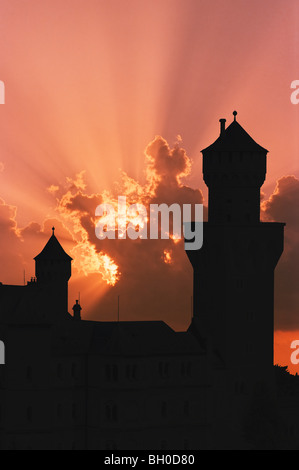 Silhouette of Neuschwanstein, worldwide famous german castle in bavarian Alps, Germany, outlined by sunset, detail. Stock Photo