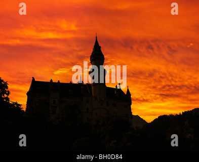 Silhouette of Neuschwanstein, worldwide famous german castle in bavarian Alps, Germany, outlined by sunset Stock Photo