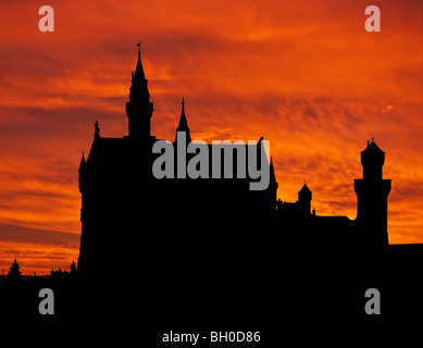 Silhouette of Neuschwanstein, worldwide famous german castle in bavarian Alps, Germany, outlined by sunset. Stock Photo