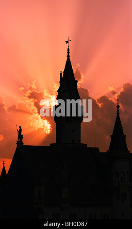 Silhouette of Neuschwanstein, worldwide famous german castle in bavarian Alps, Germany, outlined by sunset, detail. Stock Photo