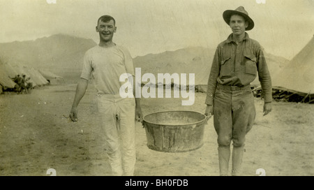 Two soldiers holding a bucket. United States Cavalrymen along the Mexican Border  Stock Photo