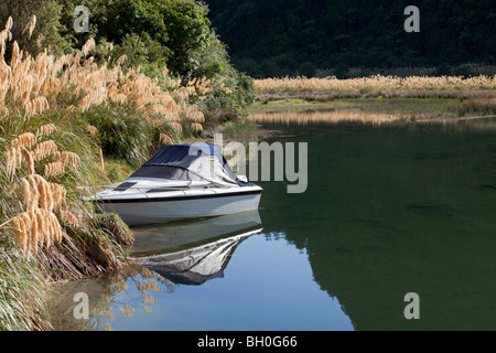 Small Fishing boat moored at Mokau Stream mouth, Lake Waikaremoana, New Zealand Stock Photo