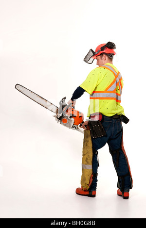 A forestry worker in protective gear holds his chainsaw. Stock Photo
