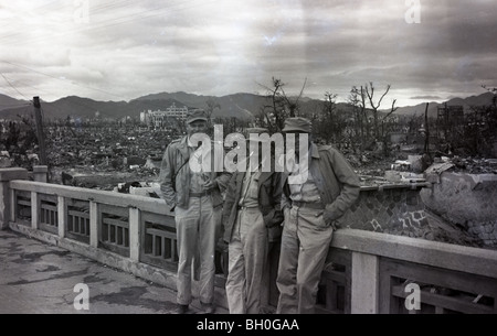 Americans posing for a photo. Scene from Hiroshima, Japan in ruins shortly after the Atomic Bomb was dropped Stock Photo