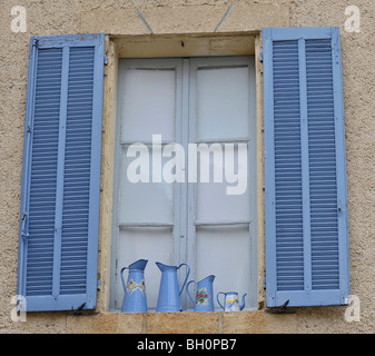 window with open blue shutters pictured in the provence, southern france Stock Photo