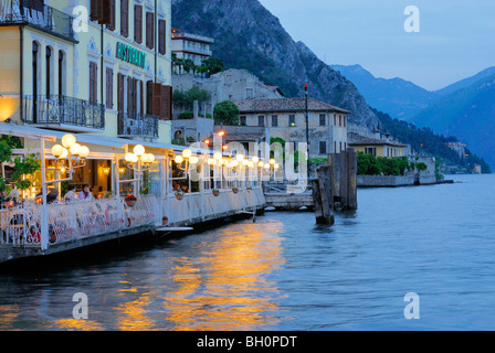 Illuminated terrace of a restaurant at lake Garda, Limone sul Garda, Lombardy, Italy Stock Photo