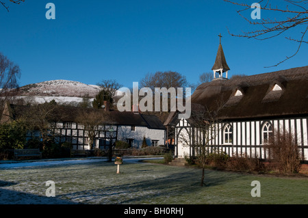 All Saint's church, Little Stretton, Shropshire, in winter with the Longmynd in the background Stock Photo