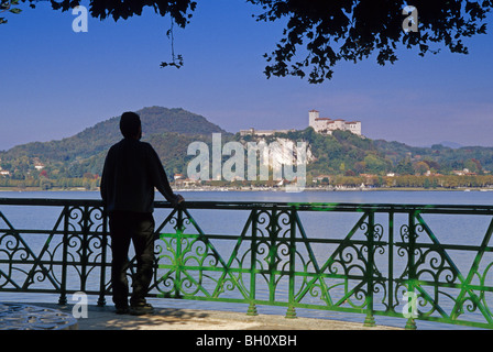 A man looking from the town Arona to fort Rocca di Angera, Lago Maggiore, Piedmont, Italy, Europe Stock Photo