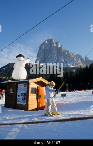 Child on a T-bar ski lift, Skiing, Winter, Sella, Seiseralm, Dolomites, South Tyrol, Italy Stock Photo