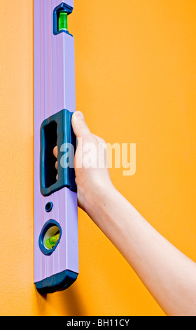 Worker check wall level using manual  level meter Stock Photo