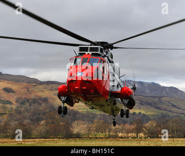 Royal Air Force (RAF) mountain rescue helicopter taking off from refuelling base at Killin, Perthshire, Scotland. Stock Photo