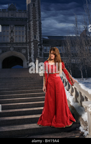 Beautiful young woman on steps dressed in Renaissance clothing Stock Photo