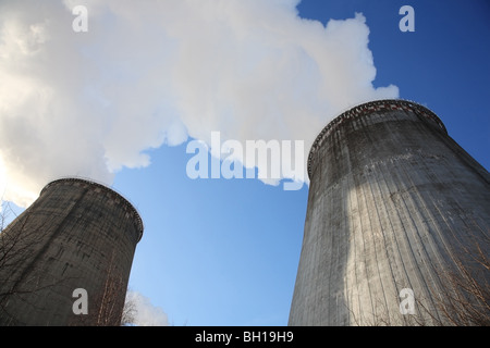 Big chimneys, steam on a blue sky background. Supply in winter. Stock Photo