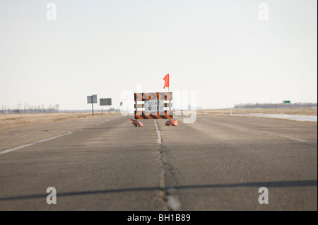 Road closed sign in middle of highway, due to Red River flooding, rural Manitoba, Canada Stock Photo