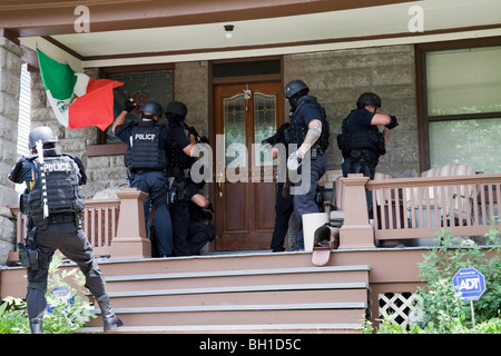 Police tactical team making entry serving a high risk drug related search warrant. Street Narcotics Unit, Kansas City, MO, PD. Stock Photo