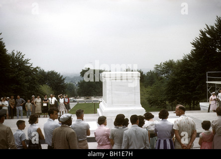A group of tourists surround the tomb of the Unknowns during the changing of the guard at Arlington National Cemetery. 50s 60s Stock Photo