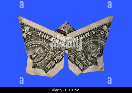 Cut Out. Origami Dollar Bill in the shape of a Butterfly on blue background. Stock Photo